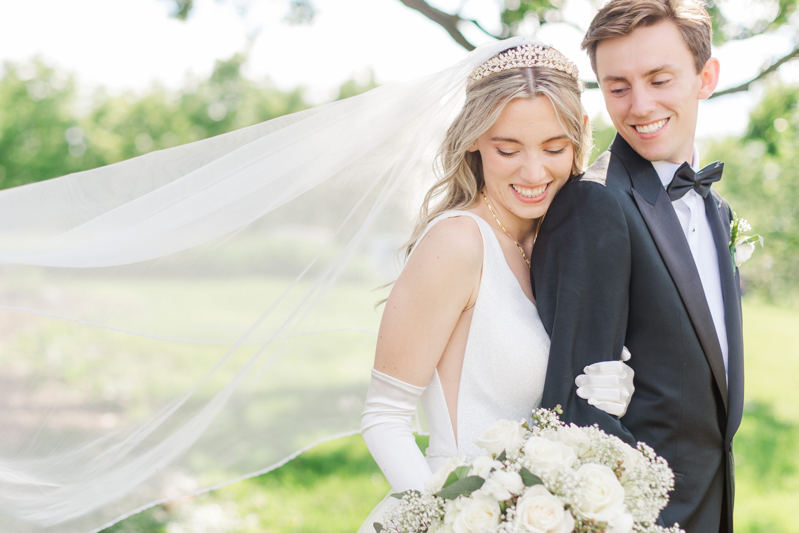 bride and groom with long veil and gloves